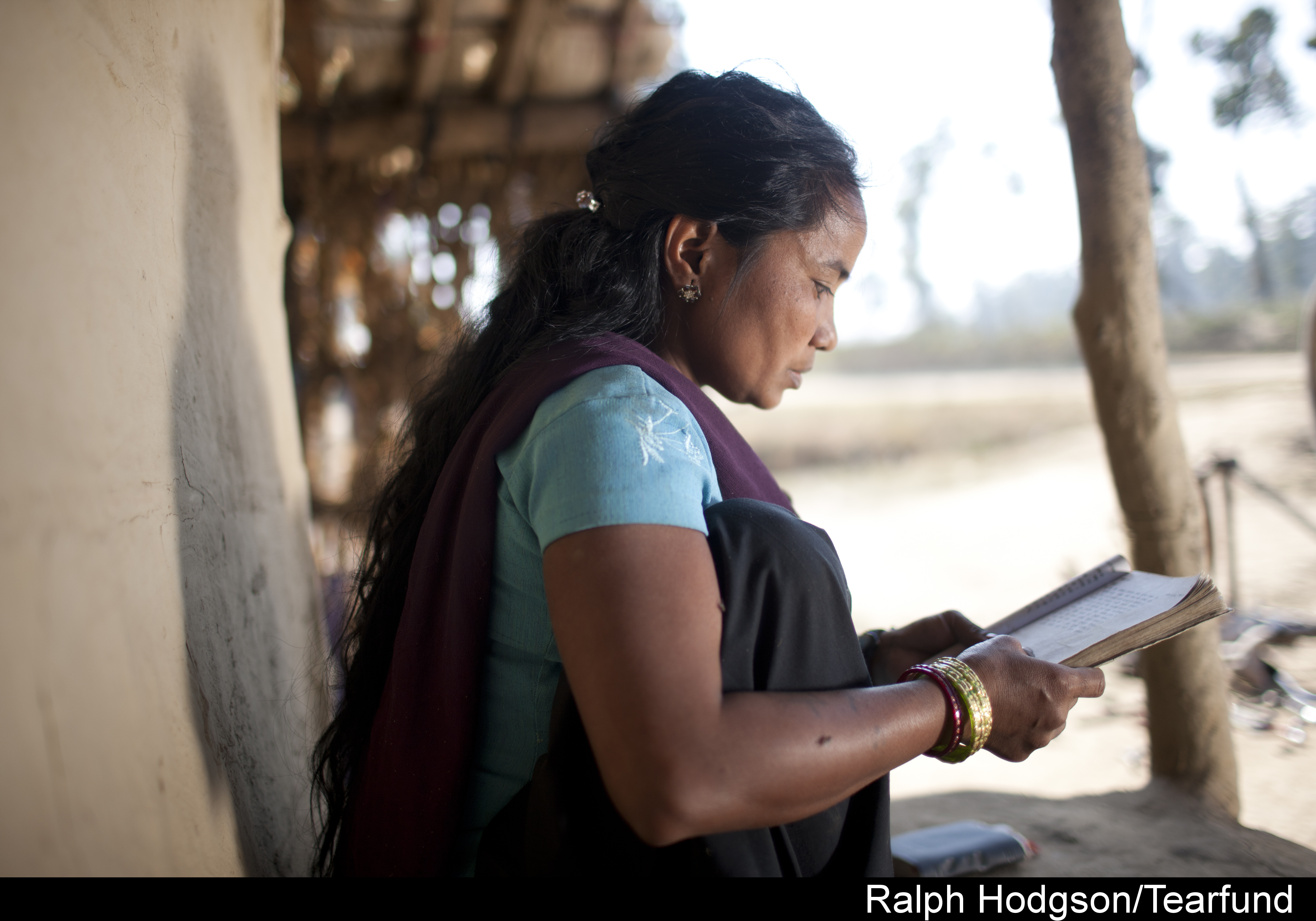 Dhandevi Seaming (32) reading bible at her home, ShivNagar community ,Tikapur, Western Nepal.TF Partner:Sagoal